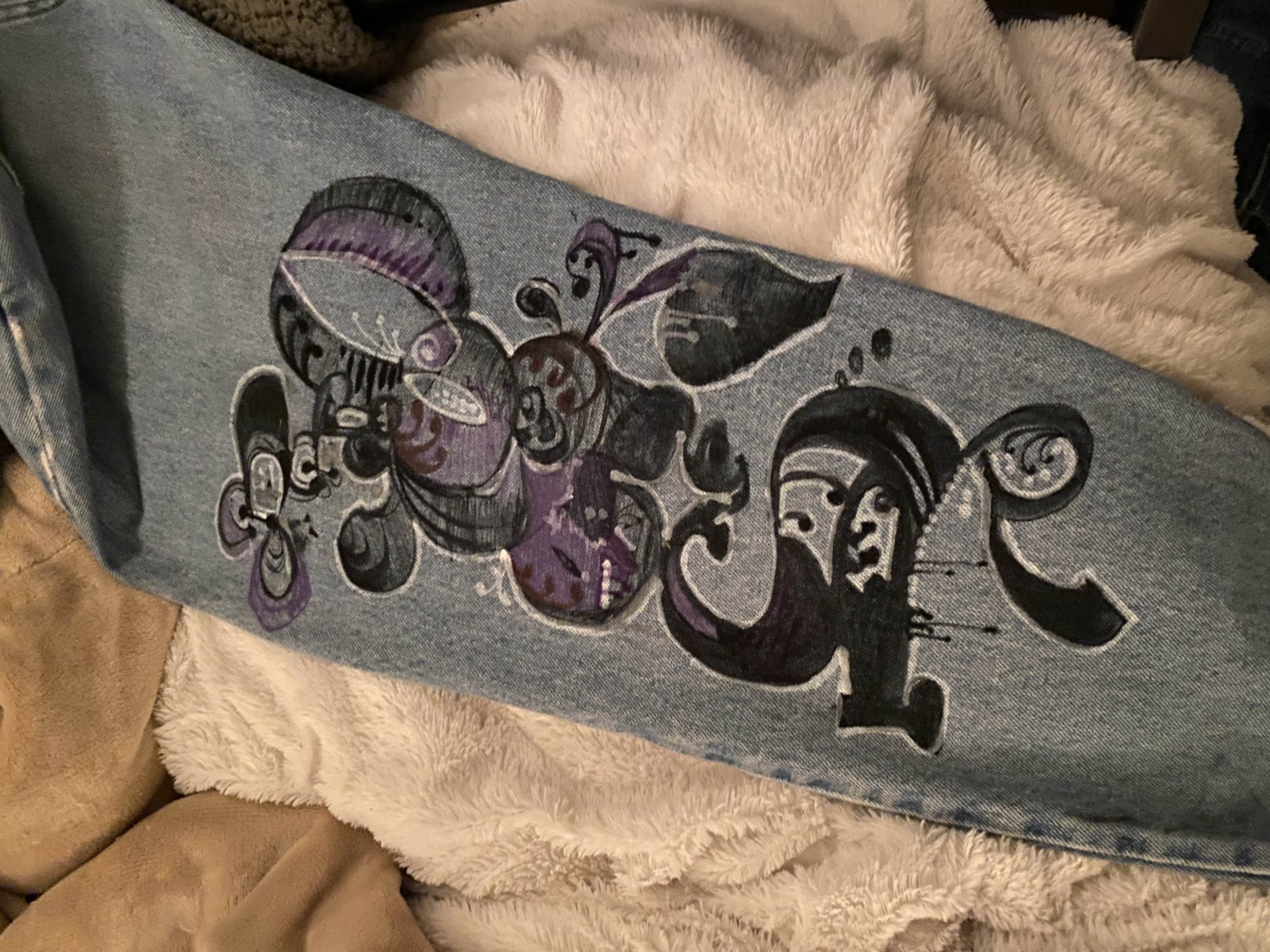 stylized lettering drawn on a pant leg